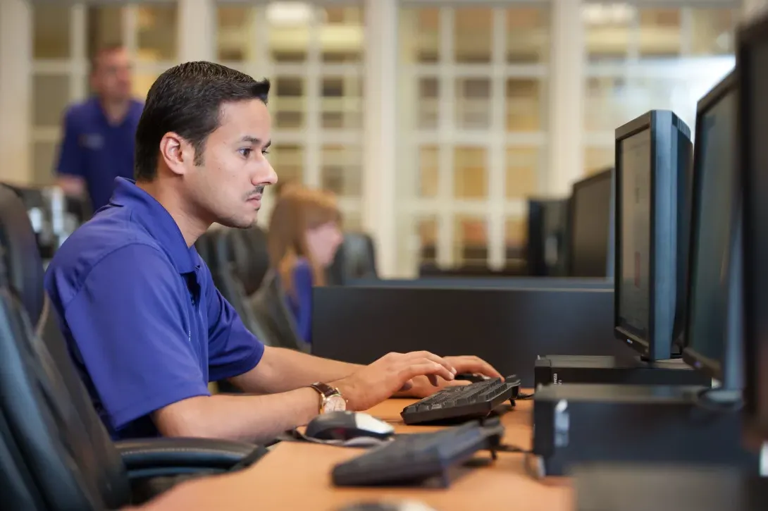 Member of Eagle Investment Group at a computer