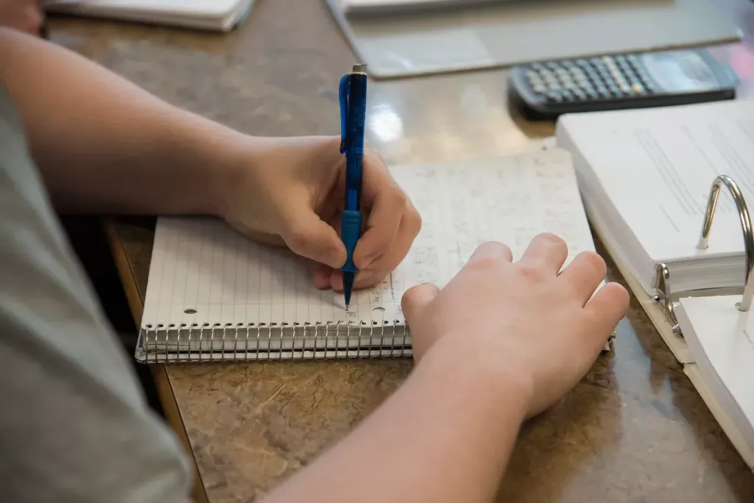 Student taking notes in math class